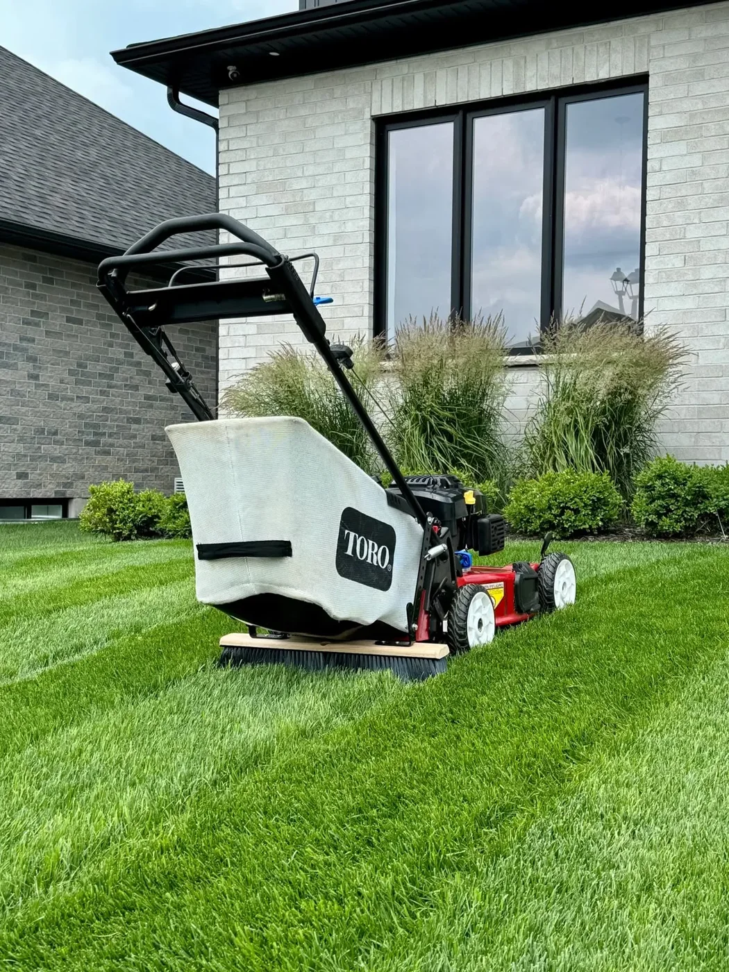 Mowing with a bagging mower — lawn and landscape photo